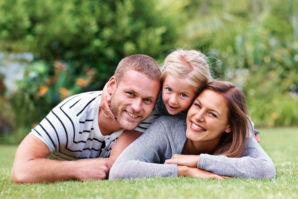 Family laying on their lawn